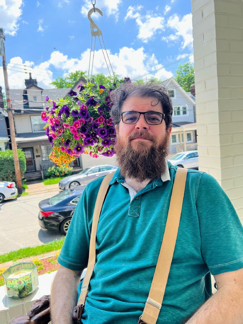 It's a picture of Raymond on his porch on a sunny day.